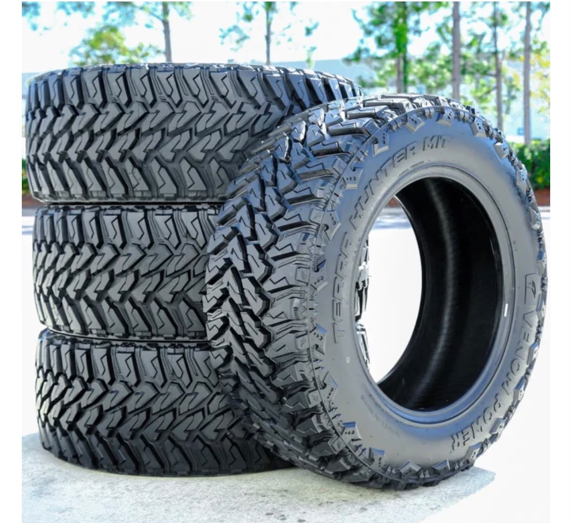 New tires ready to buy online and ship to an installer, beside a door-jamb size placard