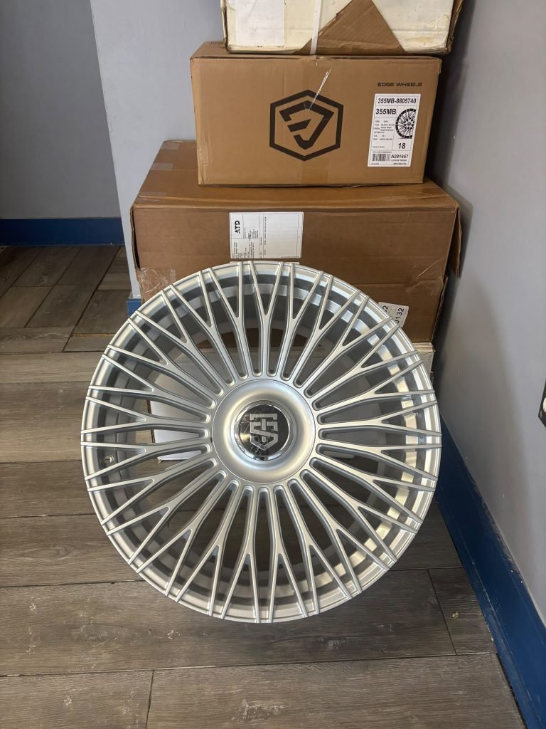 Painted	steel	wheel	beside	a	finished	alloy	wheel	showing	the	design	and	finish	difference